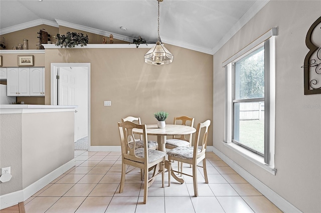 tiled dining space featuring crown molding and lofted ceiling