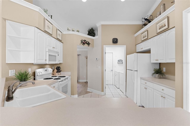 kitchen with white cabinetry, sink, crown molding, white appliances, and light tile patterned floors