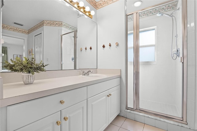 bathroom featuring vanity, tile patterned floors, and a shower with shower door