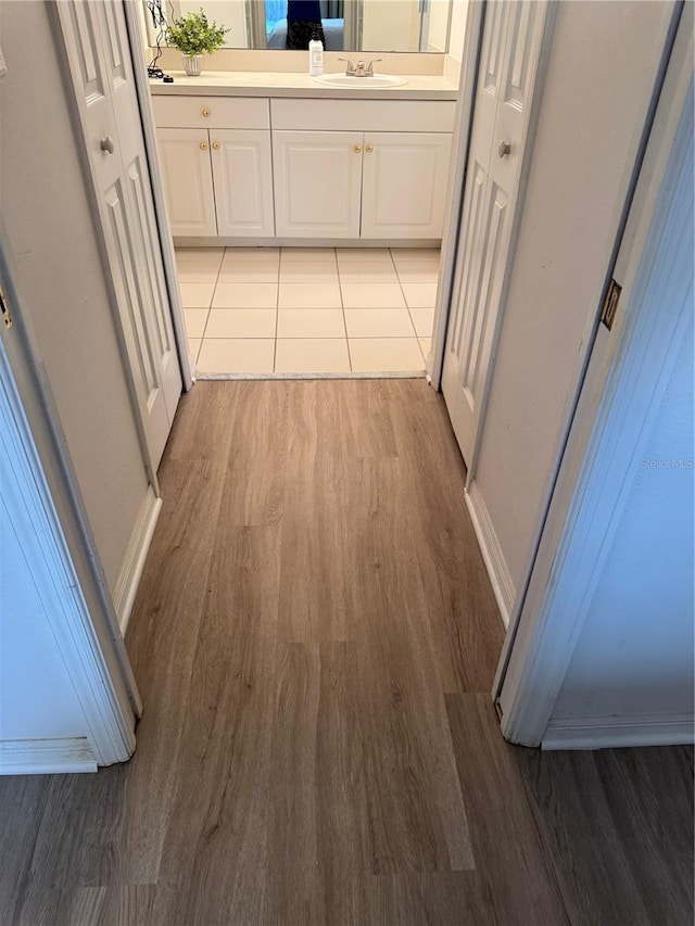 hallway featuring light hardwood / wood-style floors and sink