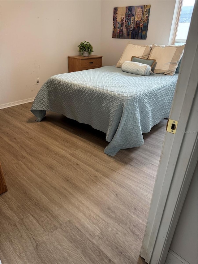 bedroom with wood-type flooring