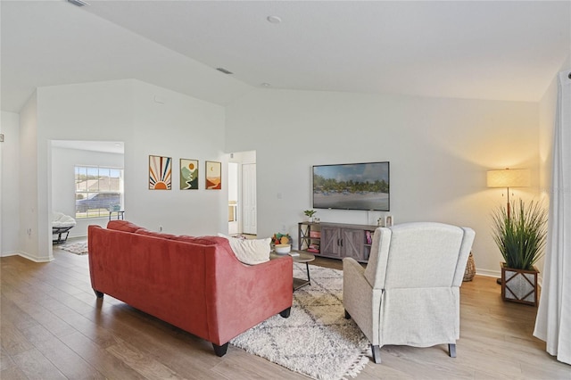 living room featuring hardwood / wood-style floors and vaulted ceiling