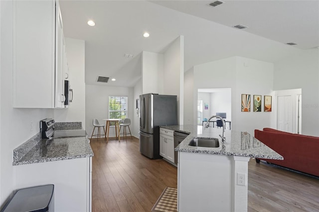 kitchen featuring light stone countertops, white cabinetry, sink, and stainless steel appliances