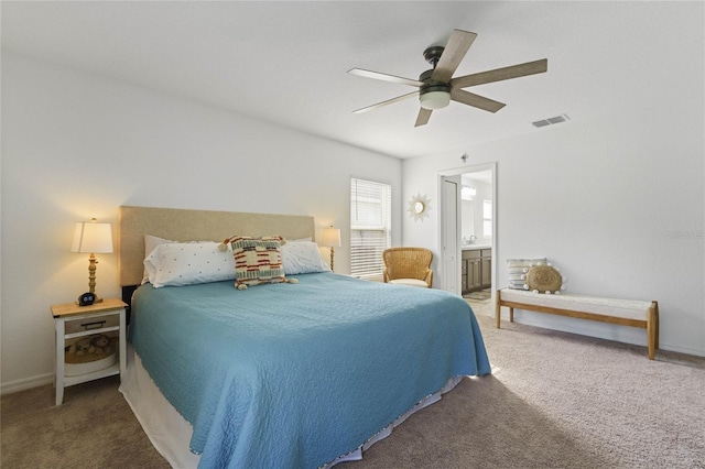 bedroom with ceiling fan, carpet flooring, and ensuite bath