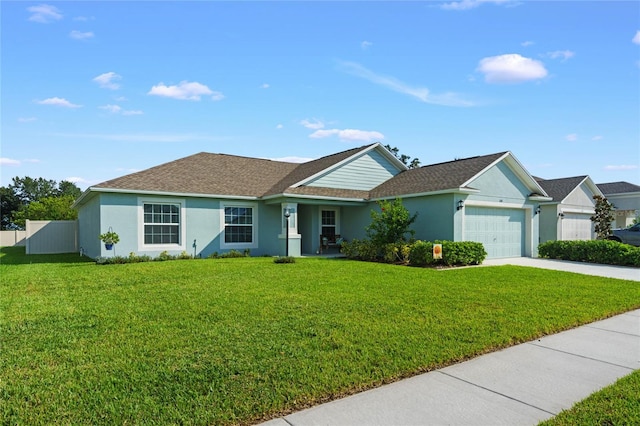 ranch-style house with a garage and a front lawn