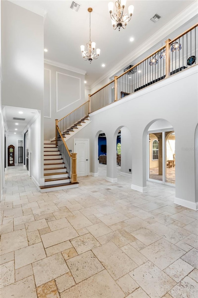 foyer with a high ceiling and ornamental molding