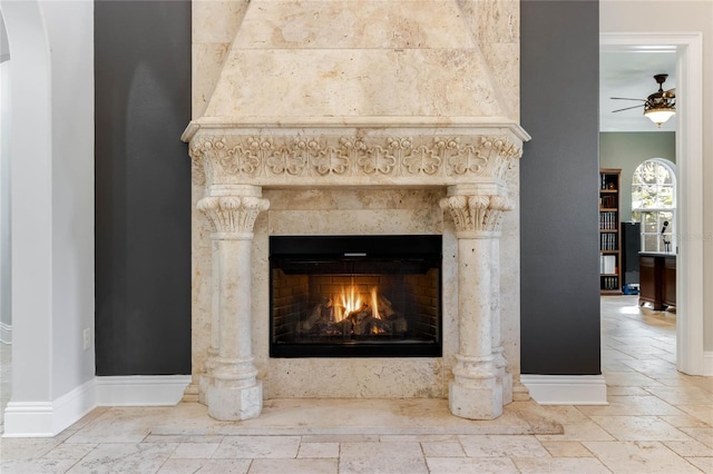 interior details with ceiling fan and a premium fireplace