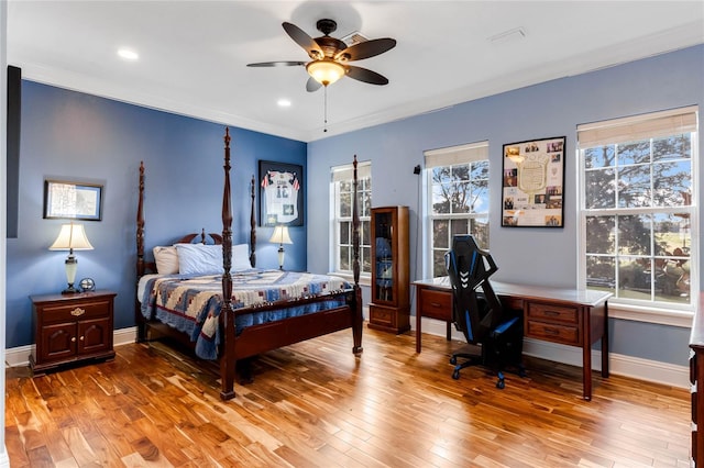 bedroom with crown molding, hardwood / wood-style floors, and ceiling fan