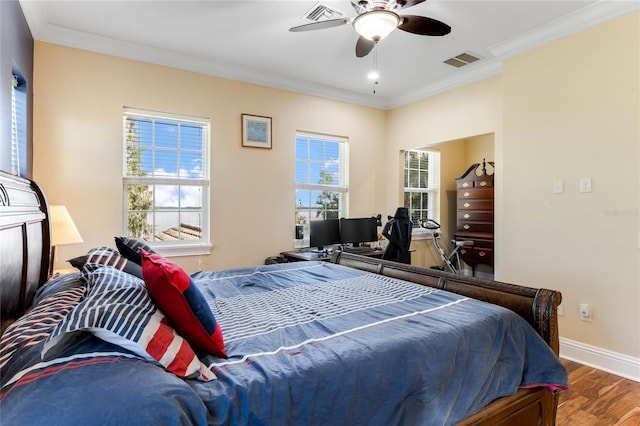 bedroom with ceiling fan, crown molding, and hardwood / wood-style floors