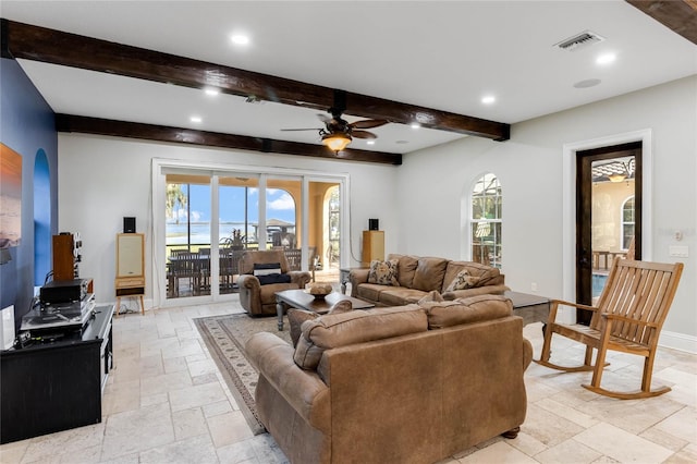 living room featuring ceiling fan, beamed ceiling, and french doors