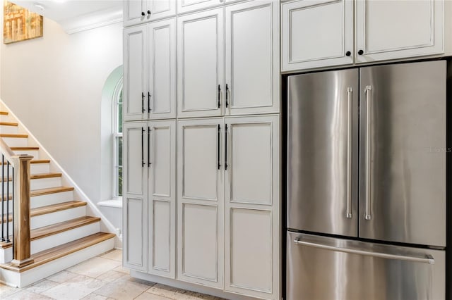 kitchen featuring stainless steel refrigerator and ornamental molding