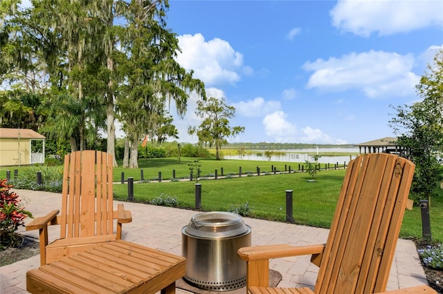 view of patio / terrace with a water view and an outdoor fire pit