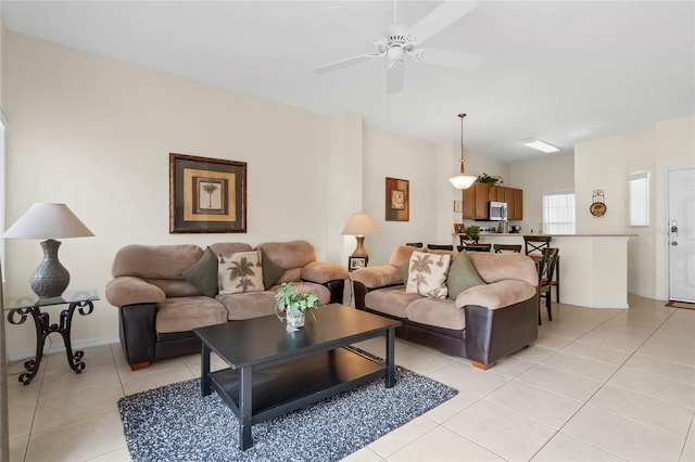 tiled living room with ceiling fan