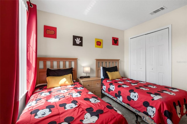 carpeted bedroom with a closet