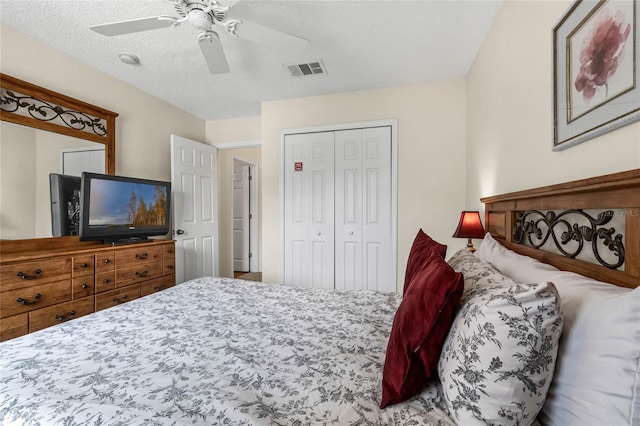 bedroom with a closet, ceiling fan, and a textured ceiling