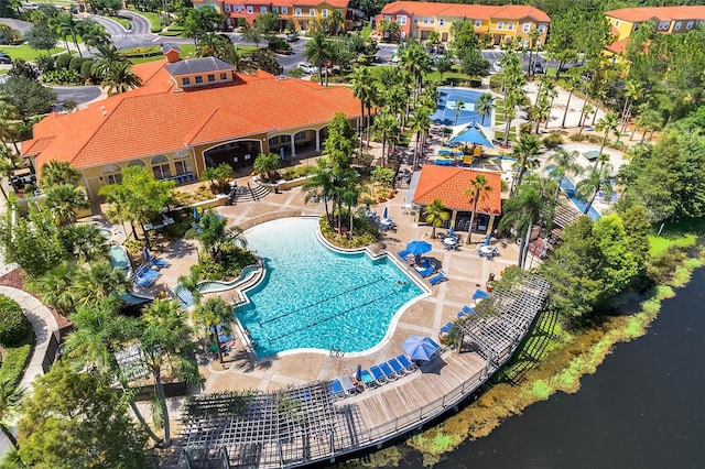 view of pool featuring a patio and a water view