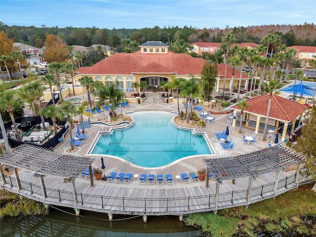 view of pool featuring a patio and a water view