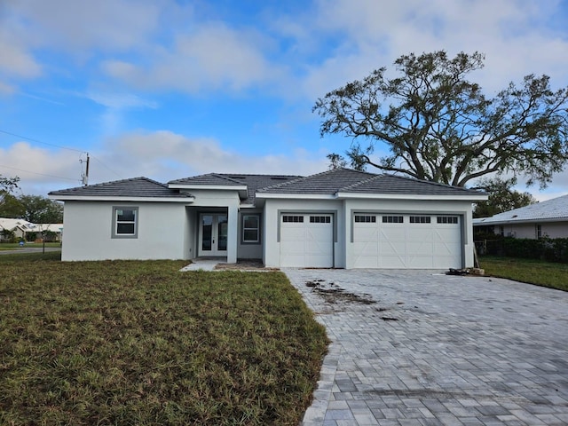 view of front of home featuring a garage and a front lawn