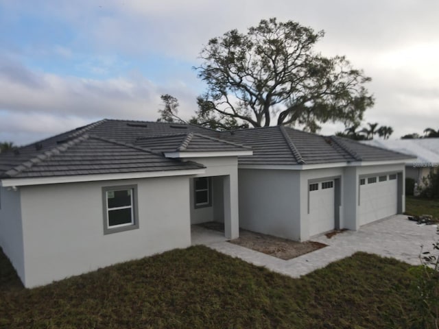 exterior space with a garage and a yard