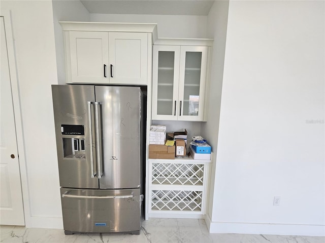 kitchen with white cabinetry and stainless steel refrigerator with ice dispenser