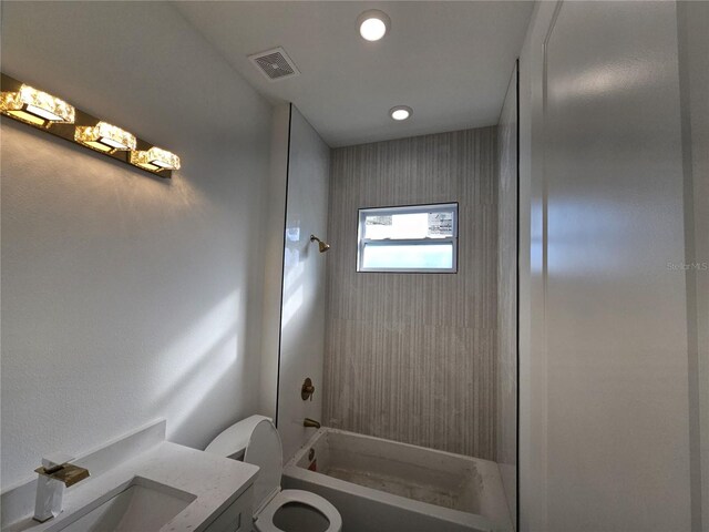 full bathroom with toilet, tiled shower / bath combo, and vanity