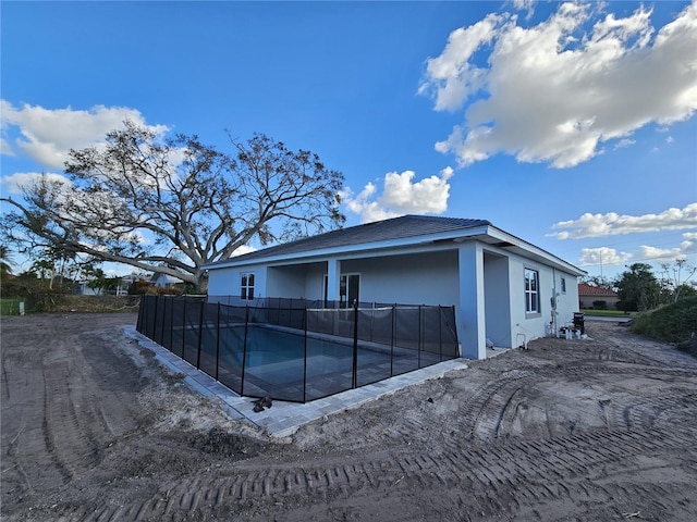 exterior space with a fenced in pool