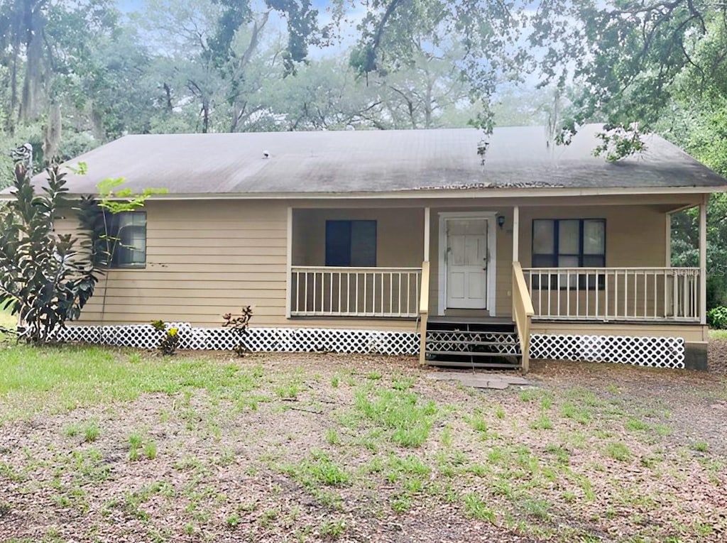 rear view of house with covered porch