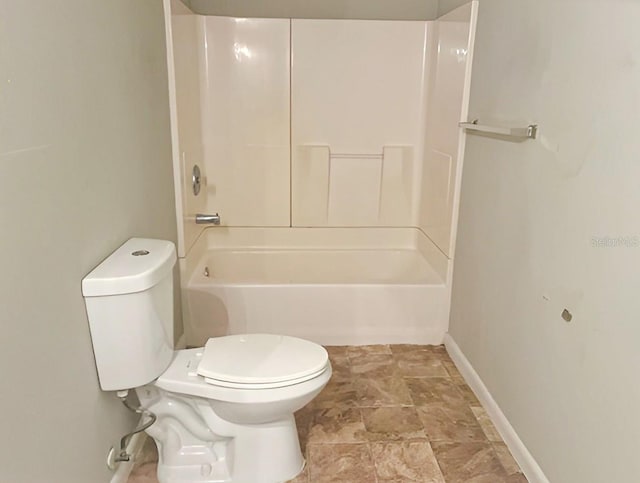 bathroom featuring tub / shower combination and toilet