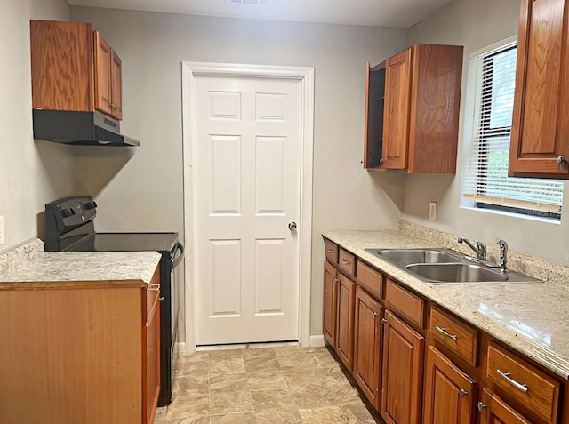 kitchen featuring black electric range, sink, and plenty of natural light