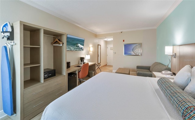 bedroom with black fridge, a closet, and crown molding