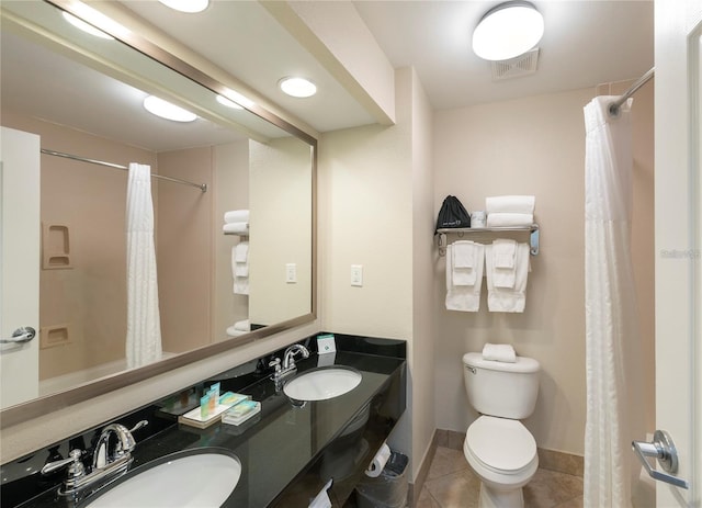 bathroom featuring tile patterned floors, toilet, vanity, and curtained shower