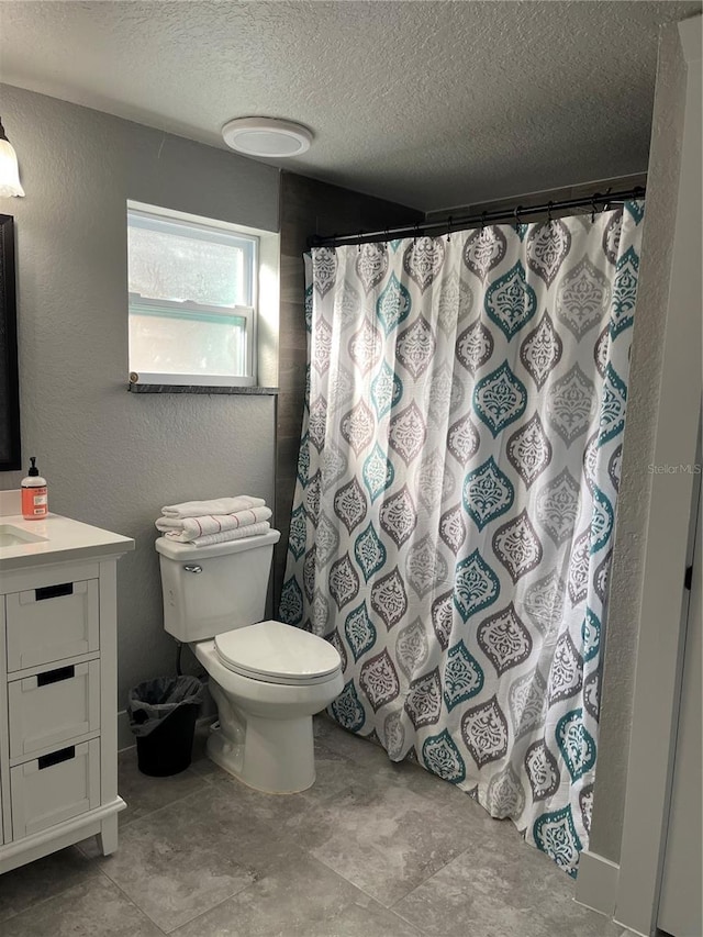 bathroom with vanity, a textured ceiling, a shower with curtain, and toilet