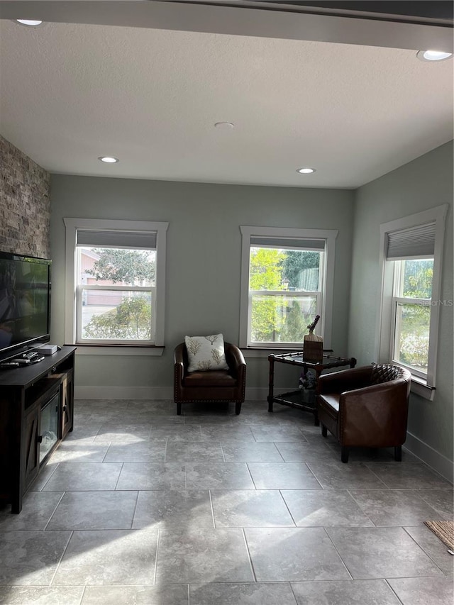 sitting room with plenty of natural light and a textured ceiling