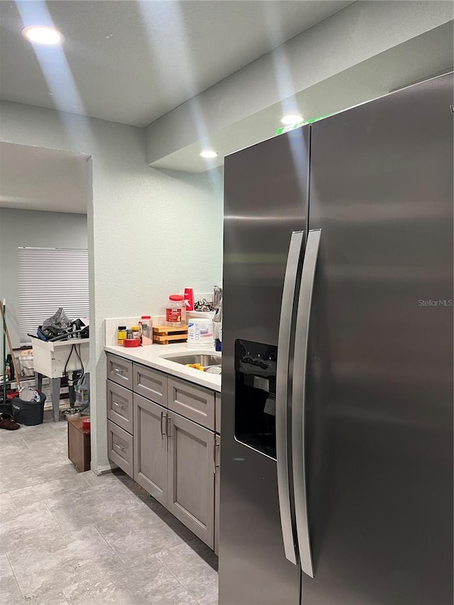 kitchen featuring stainless steel fridge with ice dispenser