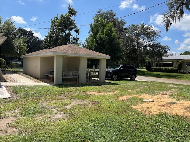 garage featuring a lawn