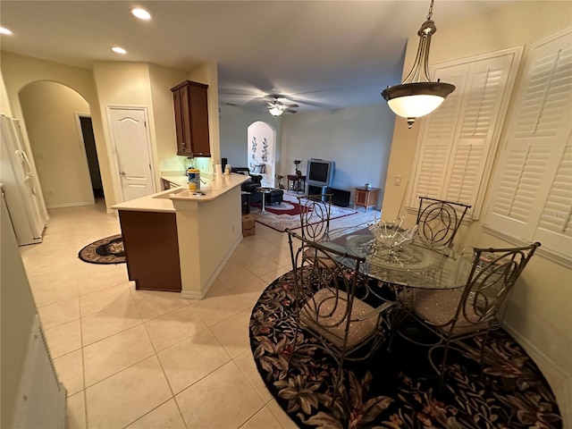 dining space with light tile patterned floors and ceiling fan