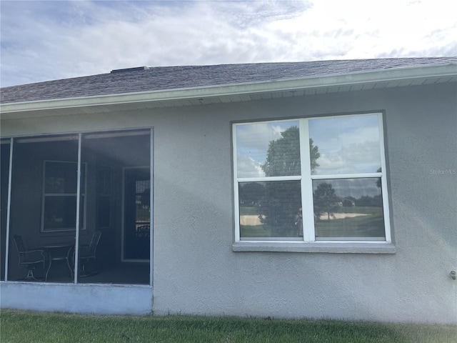 view of property exterior with a sunroom