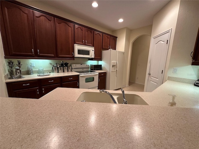 kitchen featuring sink and white appliances