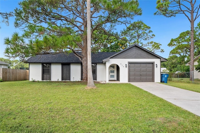 ranch-style home with a front yard and a garage