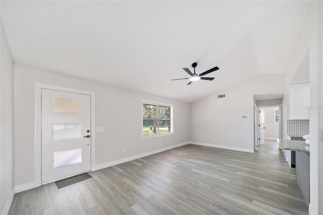 unfurnished living room featuring light wood-type flooring, lofted ceiling, and ceiling fan