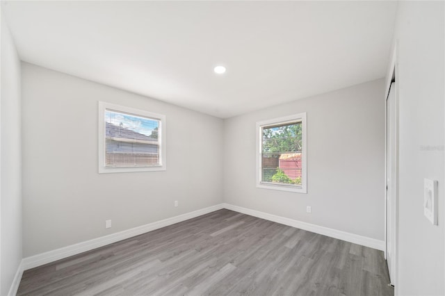 empty room with light hardwood / wood-style flooring