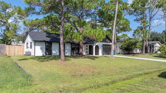 view of front of property featuring cooling unit and a front lawn