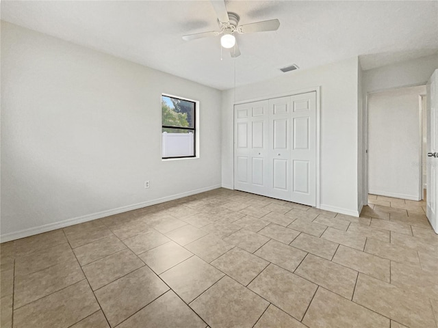 unfurnished bedroom featuring a closet, ceiling fan, and light tile patterned floors