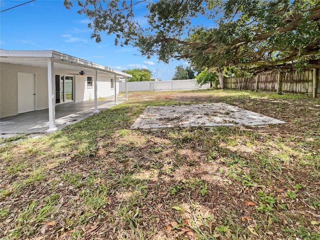 view of yard featuring a patio and ceiling fan