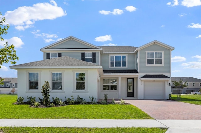 view of front of house with a garage and a front yard