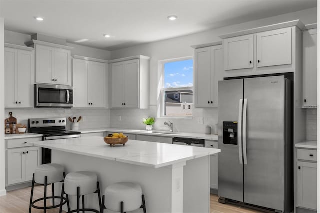 kitchen featuring appliances with stainless steel finishes, white cabinetry, and a kitchen island