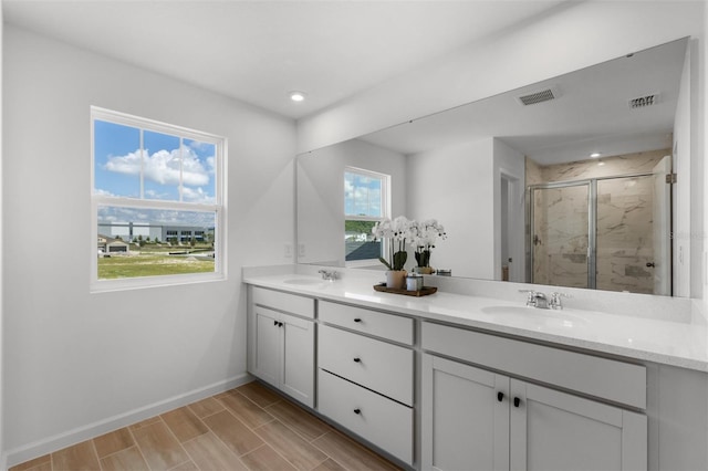 bathroom with vanity and a shower with shower door