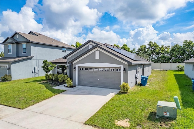 220 Bergamot Loop, Davenport, FL 33837 - view of front of home featuring stucco siding, solar panels, a garage, and concrete driveway