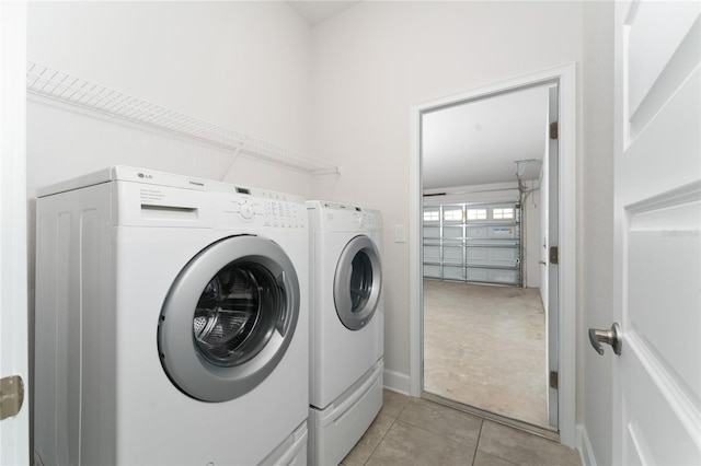 laundry area featuring light tile patterned flooring and washer and dryer