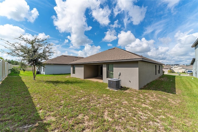 rear view of property with a yard